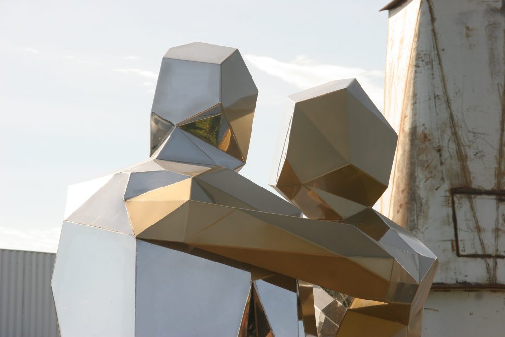 two mirror polish figures embracing 